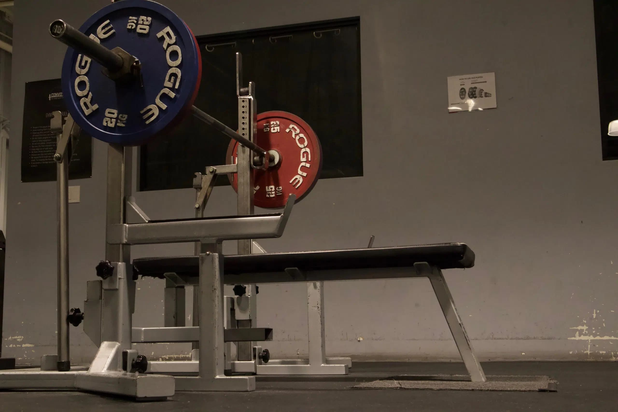 A loaded Rogue bench with calibrated plates